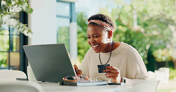 Customer smiling as she shops South African stores online with her bank card